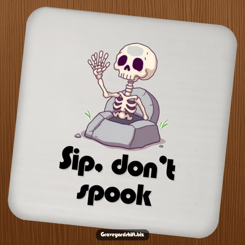 Funny giggling skeleton hand waving from a cracked grave, printed on a protective coaster for spooky beverage enjoyment.